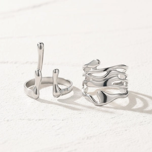 Minimalist liquid metal style silver adjustable rings set with polished organic texture