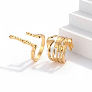 Detail of 18K gold plated liquid metal rings with a smooth polished molten finish
