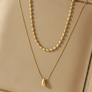 Double layered gold stainless steel necklace featuring water drop pendant and bead chain