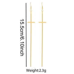 Détail de boucles d'oreilles croix à pompons en acier doré de 15,5 cm avec spécifications