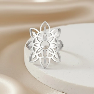 Hollow mandala flower open ring in matte silver finish on minimalist pedestal