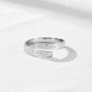 Silver stainless steel open ring with lotus and I am Enough engraving on white sand