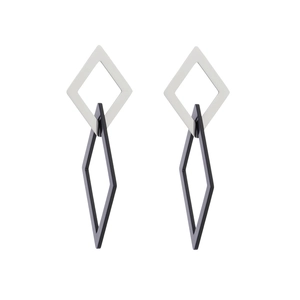 Detail of geometric silver square and black rhombus nested earrings with metal tassels