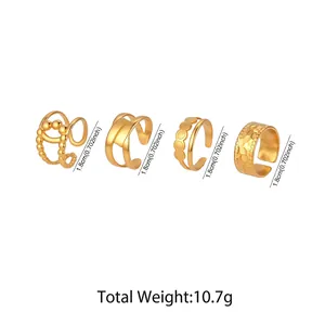 Detailed view of four adjustable gold stainless steel rings with hollow geometric patterns