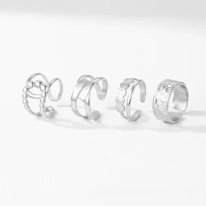 Adjustable silver hollow geometric rings set with beaded and textured metal details