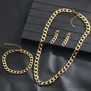 Détail de l'ensemble collier et bracelet à grosse maille gourmette dorée sur fond noir
