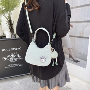 Green corduroy shoulder bag with funny duck patch and plush monster charm for women