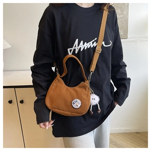Brown corduroy hobo bag with adjustable strap and cute plush charm detail view