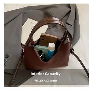 Detail of dark brown suede tote bag interior showing large capacity for essentials