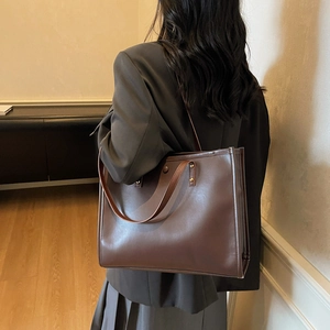 Large vintage dark brown faux leather tote bag for women showing spacious side view