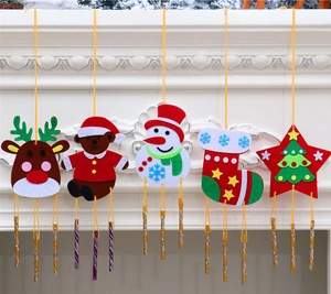Detail of five assorted DIY Christmas felt wind chimes featuring reindeer and snowmen