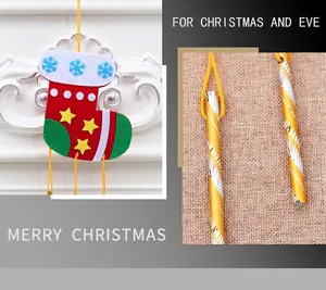 Detail of Christmas DIY wind chime featuring felt stocking with festive metal tubes
