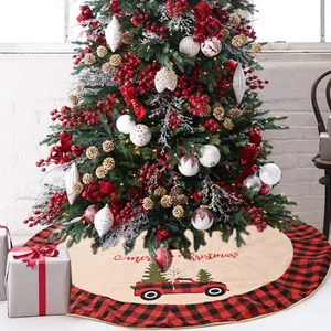 Close-up of buffalo plaid Christmas tree skirt with vintage truck pattern and festive text