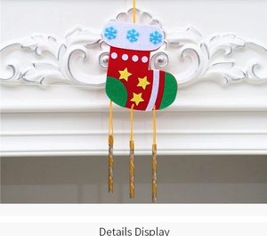 Detailed view of DIY Christmas felt wind chime with gold tubes and holiday ornaments