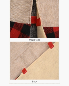 Detail of red magic tape closure and beige felt backing on plaid Christmas tree skirt