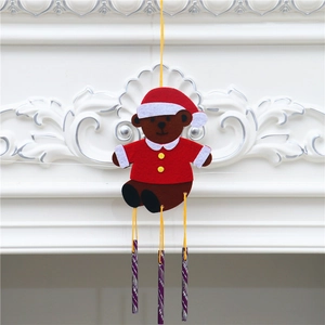 DIY Christmas wind chime featuring a teddy bear in Santa outfit hanging from a mantel