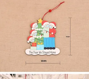 Detail view of wooden Christmas ornament with The Year We Stayed Home message and red string