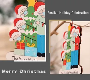Detail of wooden Christmas ornament with masked Santa and The Year We Stayed Home text