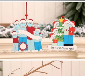 Detail of wooden Christmas ornaments featuring mask-wearing family and quarantine theme