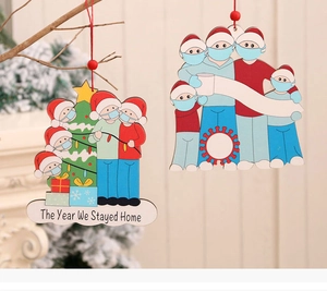 Detail of wooden Christmas ornaments featuring a family in masks with red hanging beads