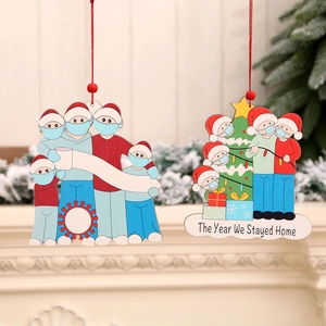 Wooden pandemic themed family Christmas ornaments featuring masked characters on fireplace