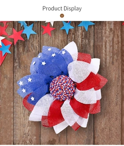 Close-up of patriotic US flag wreath with red white and blue mesh on dark wood