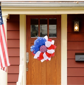 Detail of American flag wreath hanging on a front door for Independence Day decor