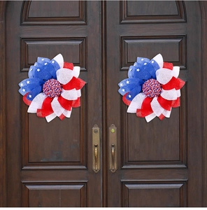 Patriotic USA flag themed mesh wreaths with red white blue colors on wooden doors