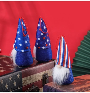 Close-up of three patriotic gnome ornaments on vintage flag case with woven ropes