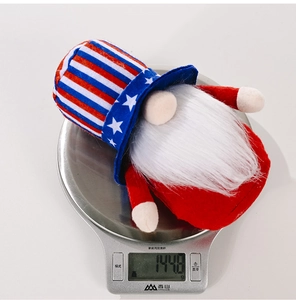 Patriotic July 4th gnome plush weighing approximately 144.8g on a digital scale
