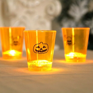 Set of three glowing Halloween LED candle cups with orange pumpkin and skull patterns