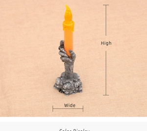 Detail of Halloween LED skull candle lamp featuring skeleton hand holding orange candle