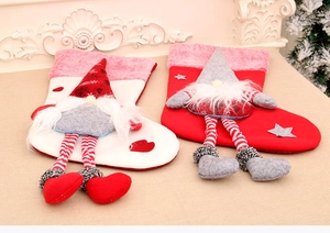 Detail of Christmas stockings with long-legged plush gnomes and festive Nordic patterns
