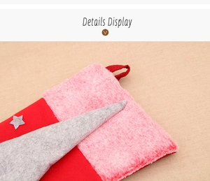 Close-up of red Christmas stocking with pink faux fur cuff and grey geometric patch detail