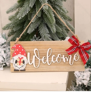 Close-up of wooden Christmas welcome sign with gnome, red polka dot hat and buffalo plaid bow