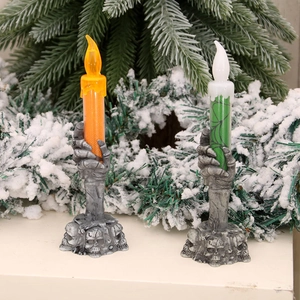 Halloween LED candle set with skeleton hand base and spider web textures on evergreen branch