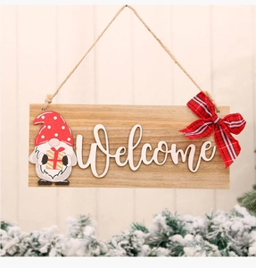 Macro detail of wooden Christmas Welcome sign with gnome and red checkered bow