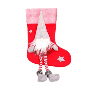 Christmas stocking with plush faceless forest gnome and long striped legs for decoration