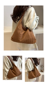 Detail of soft brown faux suede tote bag showing texture and wide shoulder strap