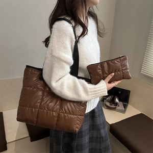 Brown quilted puffer tote bag with matching pouch shown on model for autumn style