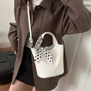 White litchi pattern leather bucket bag with decorative polka dot silk scarf handle