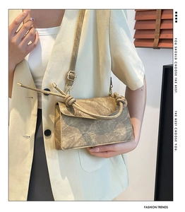 Detail showing the vintage matte rectangular handbag with unique top knot handle and strap