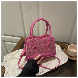 Close-up of pink faux shearling texture and leather trim on this trendy crossbody bag
