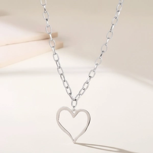 Collier minimaliste en acier inoxydable avec pendentif cœur ajouré sur une chaîne argentée