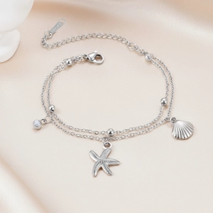 Detailed view of stainless steel starfish bracelet with zircon charms on pink satin