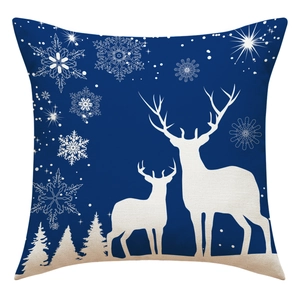 Close-up of blue linen Christmas pillowcase with white reindeer and snowflake patterns
