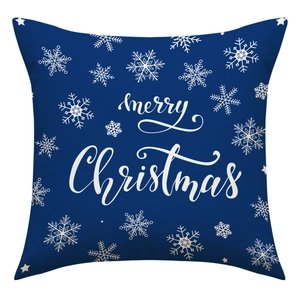Detail of navy blue linen Christmas pillowcase with white Merry Christmas text and snowflakes