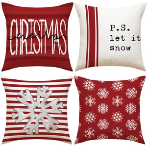Detail view of four Christmas pillow covers with snowflakes and festive lettering prints
