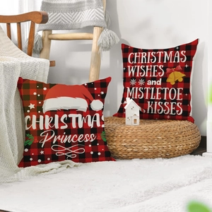 Set of 2 Christmas buffalo plaid pillow covers with festive lettering on white rug
