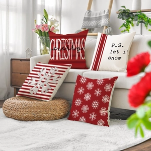Set of 4 Christmas pillow covers with snowflake and letter motifs on a white sofa